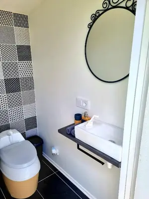 a bathroom with a sink and a mirror at Glamping Zarasai in Palivarkas