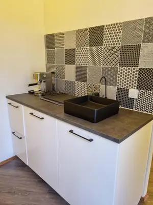 a kitchen with a sink and a counter top at Glamping Zarasai in Palivarkas