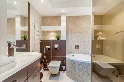 a bathroom with a tub and a toilet and a sink at Central Apartment in Gedimino Av by URBAN RENT in Vilnius