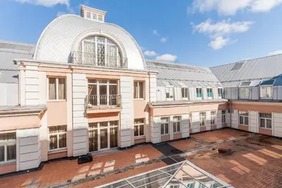 a large building with a large window and a roof at Central Apartment in Gedimino Av by URBAN RENT in Vilnius