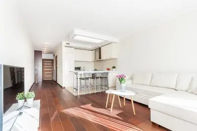 a living room with a white couch and a table at Central Apartment in Gedimino Av by URBAN RENT in Vilnius