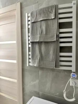 a towel rack in a bathroom with towels at Wolfie Apartment, City Center in Vilnius