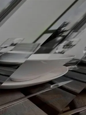 a row of white plates sitting on a table at Wolfie Apartment, City Center in Vilnius