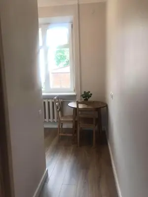 a dining room with a table and a window at Vytauto Septyni in Zarasai