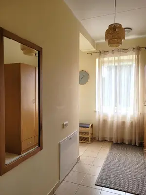 a bathroom with a large mirror and a window at Jono Pauliaus II piligrimu namai in Raseiniai