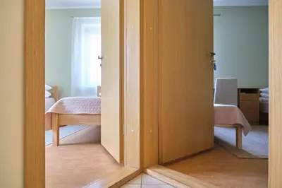 an open door to a room with a bedroom at Jono Pauliaus II piligrimu namai in Raseiniai
