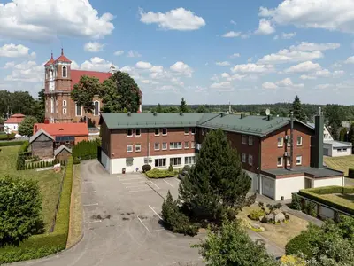 an aerial view of a building with a church at Jono Pauliaus II piligrimu namai in Raseiniai