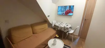 a living room with a couch and a table at Loft style apartments in Kaunas center in Kaunas