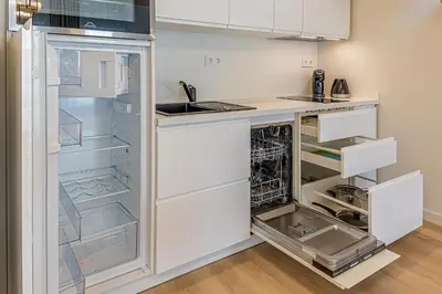 a kitchen with an open refrigerator with the door open at Modern Loft Apartment w/free parking No.2 in Marijampolė