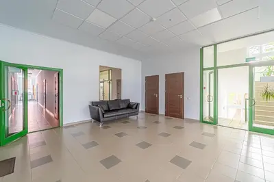 a black leather couch in a room with glass doors at Modern Loft Apartment w/free parking No.2 in Marijampolė