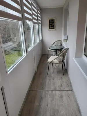 a room with a table and chairs and a window at Vanilės home in Šiauliai