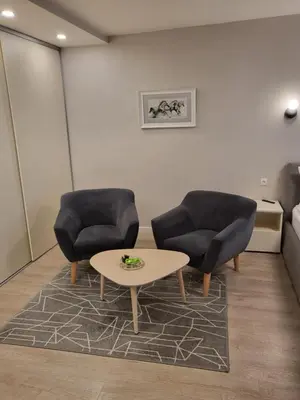 two chairs and a coffee table in a room at Vanilės home in Šiauliai