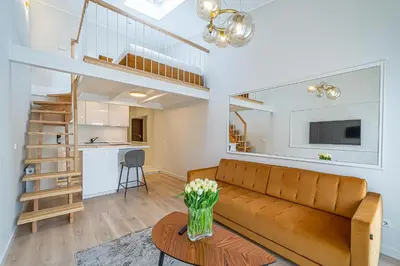 a living room with a couch and a table at Modern Loft Apartment w/free parking No.3 in Marijampolė