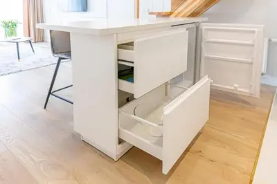 a white kitchen island with a white counter top at Modern Loft Apartment w/free parking No.3 in Marijampolė