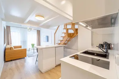 a white kitchen with a sink and a stove at Modern Loft Apartment w/free parking No.3 in Marijampolė