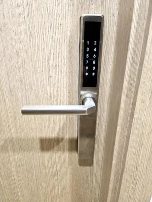 a close up of a door handle on a wooden door at Kauno apartamentai king size bed in Kaunas