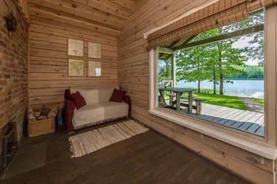 a room with a window in a log cabin at Vila Shakti in Rudžionys