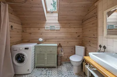 a bathroom with a washing machine and a toilet at Vila Shakti in Rudžionys