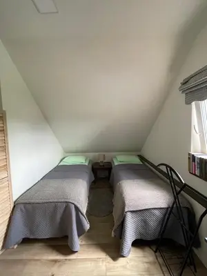 a room with two beds in a attic at Mėta House in Merkinė