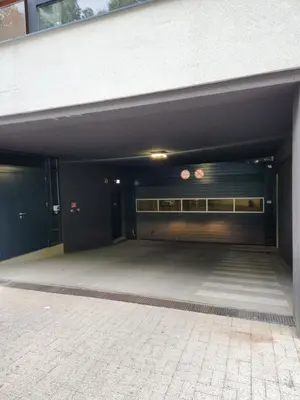 an empty parking garage with two garage doors at Prie Vilneles Apartment in Vilnius