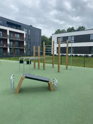 a playground with a slide on a green field at Prie Vilneles Apartment in Vilnius