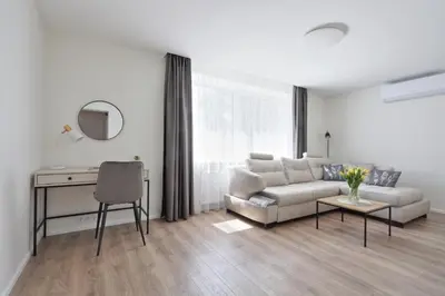 a living room with a couch and a table at Aušros apartamentai in Utena
