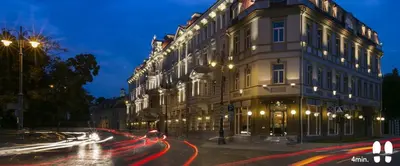 a large building on a city street at night at Panoramic Loft - Lollo Luxury in Vilnius
