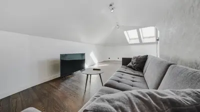 a living room with a couch and a tv at Panoramic Loft - Lollo Luxury in Vilnius