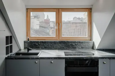 a kitchen with a sink and a window at Panoramic Loft - Lollo Luxury in Vilnius