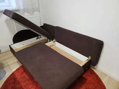 a brown couch sitting on a rug in a room at Kauno apartamentai 1 bed room in Kaunas