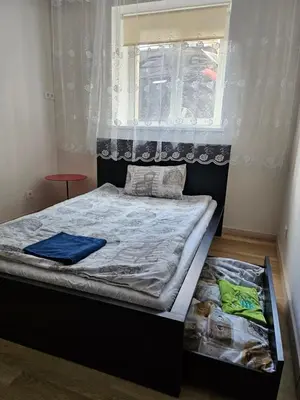 a small bedroom with a bed with a window at Kauno apartamentai 1 bed room in Kaunas