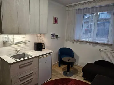 a small kitchen with a sink and a table at Kauno apartamentai 1 bed room in Kaunas