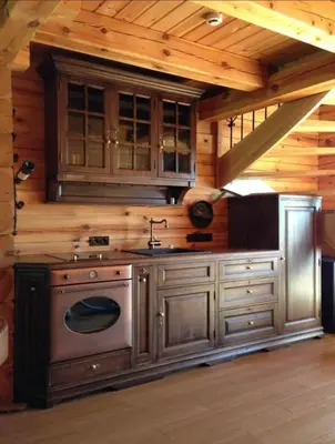 a kitchen with a stove top oven in a cabin at Pas sesutes sodyba in Pamarnakai