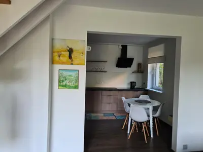 a kitchen and dining room with a table and chairs at GREEN HOUSE in Anykščiai