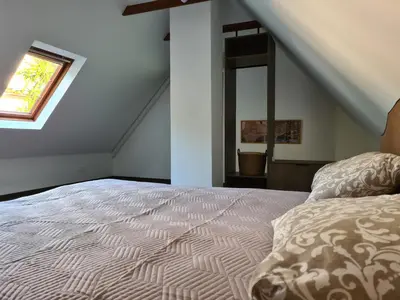 a bedroom with a bed and a window at GREEN HOUSE in Anykščiai