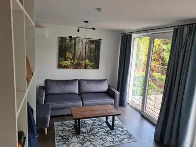 a living room with a couch and a table at GREEN HOUSE in Anykščiai