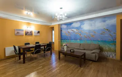 a dining room with a large painting on the wall at Abariaus Apartamentai in Druskininkai