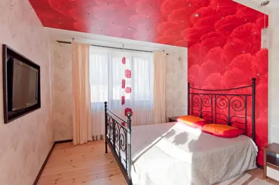 a bedroom with a bed with a red ceiling at Abariaus Apartamentai in Druskininkai