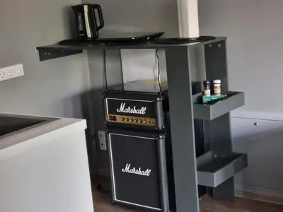 a small kitchen with a black and white stove at Park apartments in Rokiškis