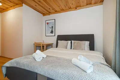 a bedroom with a large bed with towels on it at Villa Green in Molėtai