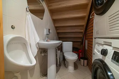 a small bathroom with a sink and a toilet at Villa Green in Molėtai