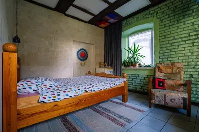 a bedroom with a wooden bed and a window at Kabina in Pakruojis