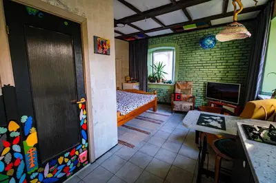 a room with a bedroom with a bed and a door at Kabina in Pakruojis
