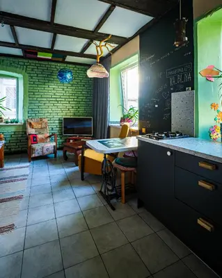a kitchen with a table and a dining room at Kabina in Pakruojis