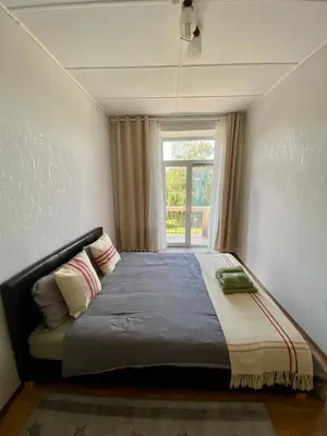 a bedroom with a large bed with a window at Oldtown castle view apartment in Kaunas