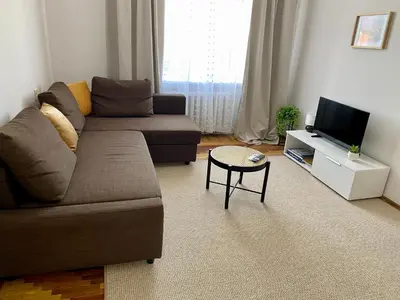 a living room with a couch and a tv at Oldtown castle view apartment in Kaunas