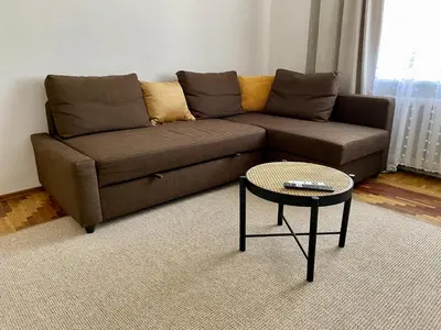 a living room with a brown couch and a table at Oldtown castle view apartment in Kaunas