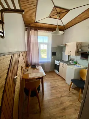 a small kitchen with a table and a dining room at Oldtown castle view apartment in Kaunas