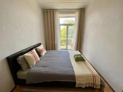 a bed in a room with a window at Oldtown castle view apartment in Kaunas
