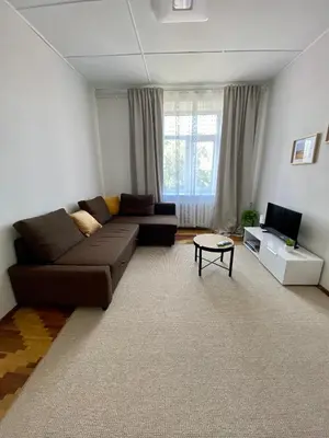 a living room with a couch and a tv at Oldtown castle view apartment in Kaunas